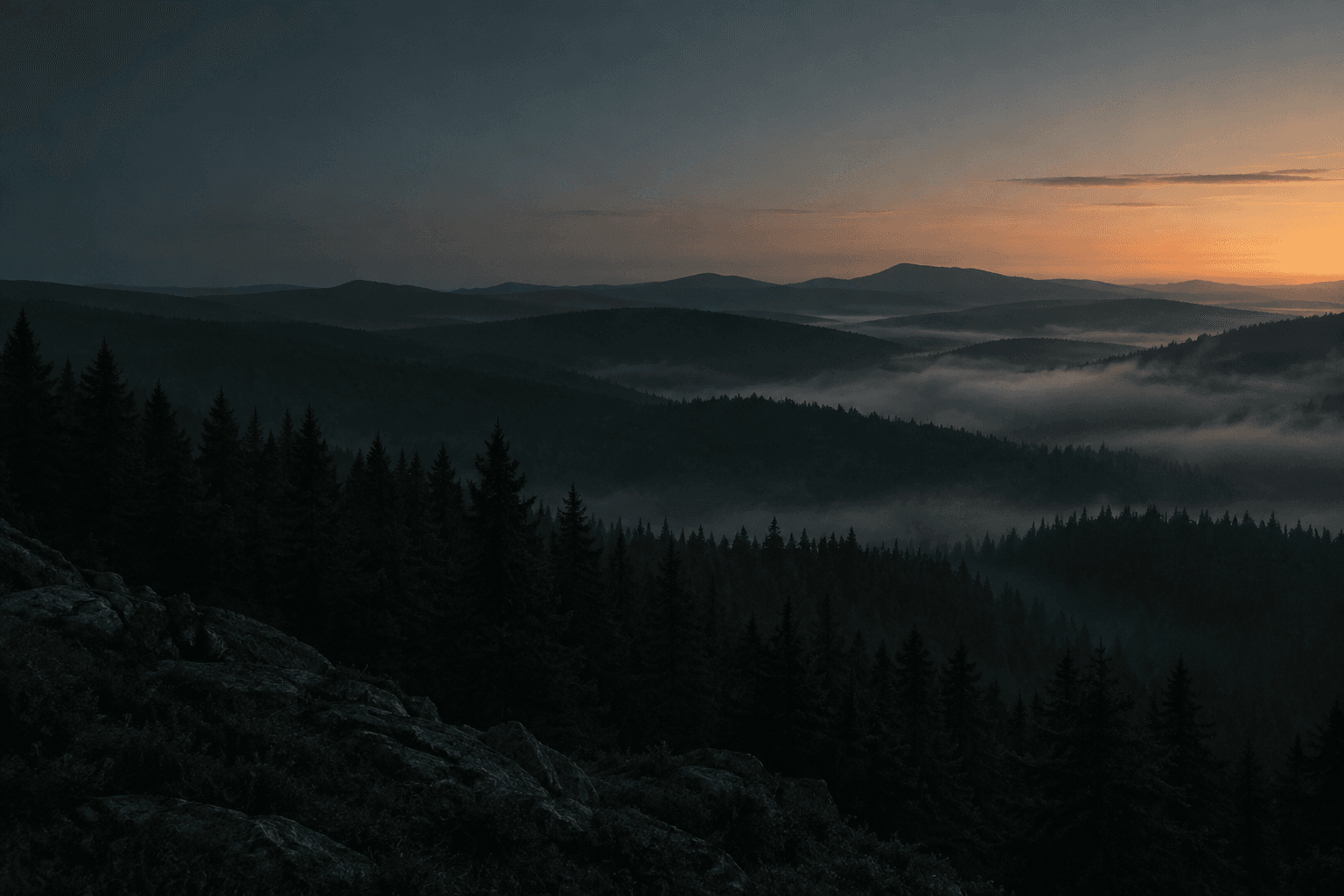 Misty forested hills at sunrise